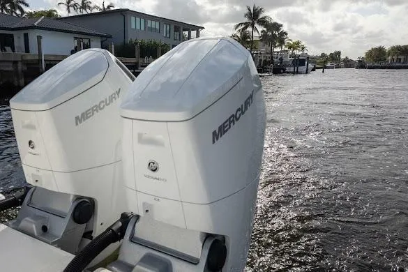  Yacht Photos Pics 2022 Tiara Sport 43 LE with twin Mercury outboard engines on a sunny waterfront.