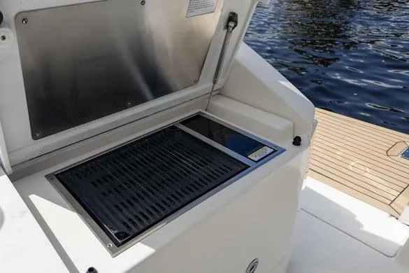  Yacht Photos Pics Outdoor grill on 2022 Tiara Sport 43 LE boat, near water.