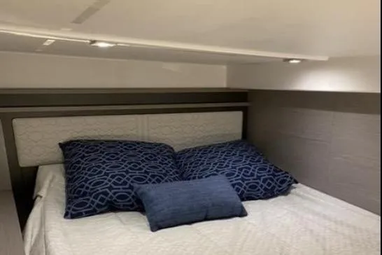  Yacht Photos Pics 2022 Tiara Sport 43 LE cabin with cozy bed and blue pillows.