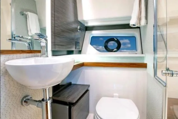  Yacht Photos Pics 2022 Tiara Sport 43 LE yacht bathroom with modern sink, toilet, and window view.