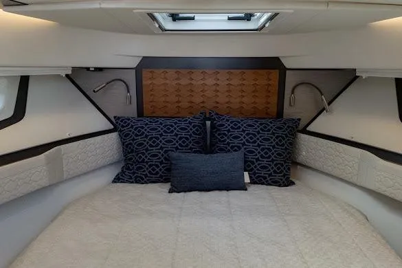  Yacht Photos Pics Luxurious cabin interior of 2022 Tiara Sport 43 LE with elegant bedding and modern lighting.