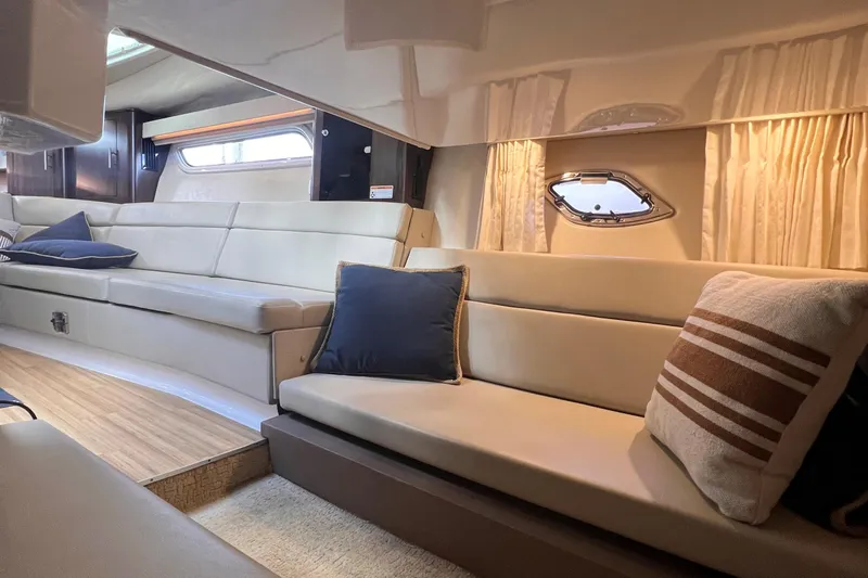  Yacht Photos Pics Interior of 2016 Regal 35 Sport Coupe with beige seating and decorative pillows.