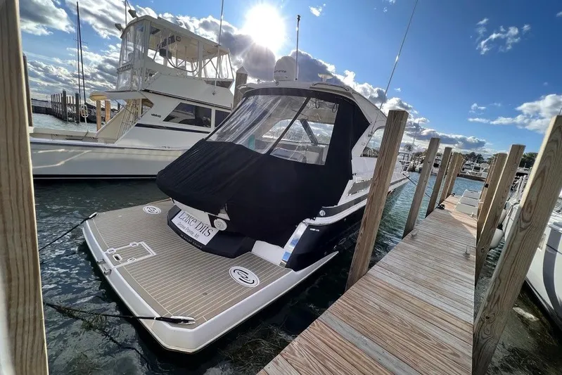  Yacht Photos Pics 2016 Regal 35 Sport Coupe docked at marina under sunny skies.
