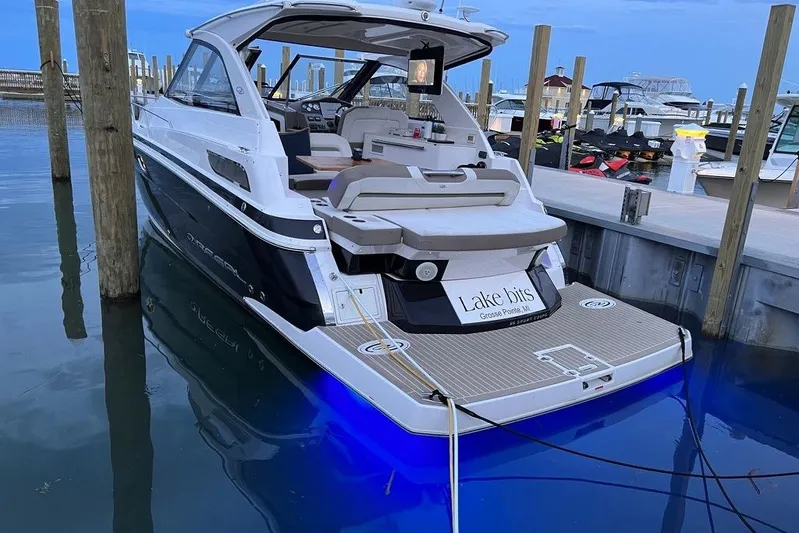  Yacht Photos Pics 2016 Regal 35 Sport Coupe docked at marina with blue underwater lights.
