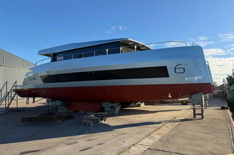 New Moon 60 Power Yacht Photos Pics 2025 Moon 60 Power yacht on dry dock under clear blue sky.