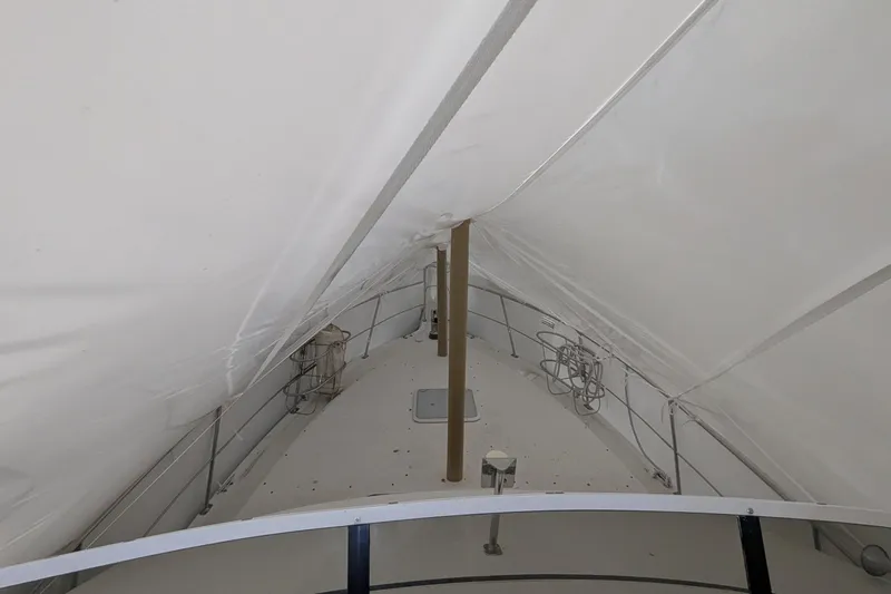 Synchronicity Yacht Photos Pics 2000 Carver 404 Cockpit Motor Yacht under protective cover, showcasing deck details.