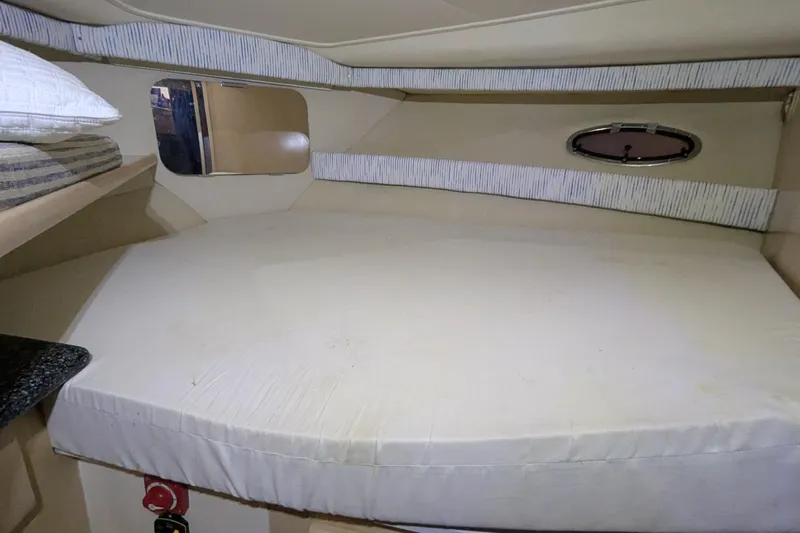 Synchronicity Yacht Photos Pics Interior cabin of 2000 Carver 404 Cockpit Motor Yacht with bed and porthole.