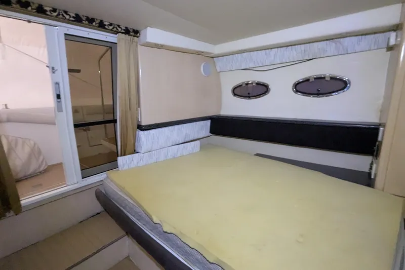 Synchronicity Yacht Photos Pics Interior cabin of 2000 Carver 404 Cockpit Motor Yacht with bed and portholes.