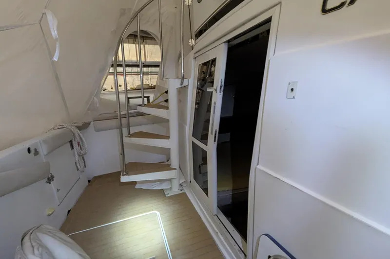 Synchronicity Yacht Photos Pics Interior of 2000 Carver 404 Cockpit Motor Yacht with spiral staircase and sliding door.