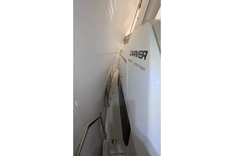 Synchronicity Yacht Photos Pics 2000 Carver 404 Cockpit Motor Yacht side view with sleek design and railing.