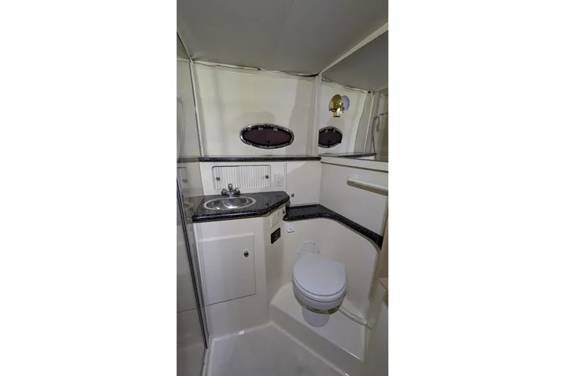 Synchronicity Yacht Photos Pics Bathroom interior of 2000 Carver 404 Cockpit Motor Yacht with sink and toilet.