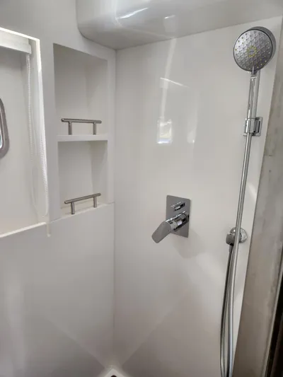  Yacht Photos Pics Modern shower area in 2025 Heysea Seaview 56 yacht, featuring sleek fixtures and storage shelves.