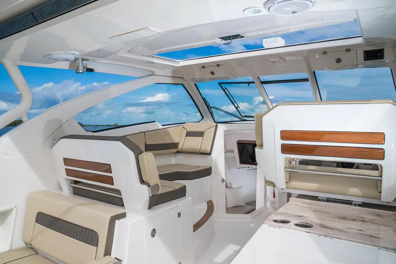  Yacht Photos Pics Manufacturer Provided Image: Interior of 2018 Pursuit DC 365 Dual Console boat with luxurious seating and panoramic windows.