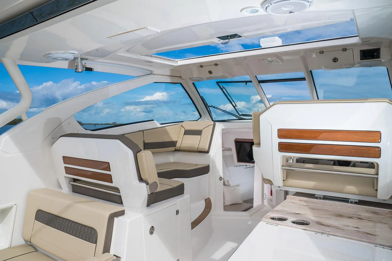 Manufacturer Provided Image: Interior of 2018 Pursuit DC 365 Dual Console boat with luxurious seating and panoramic windows.