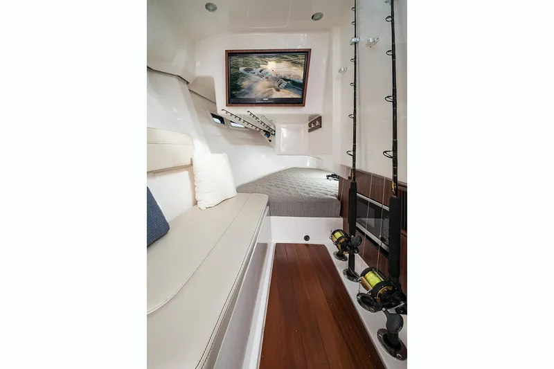  Yacht Photos Pics Manufacturer Provided Image: 2018 Pursuit DC 365 Dual Console cabin interior with fishing rods and seating.