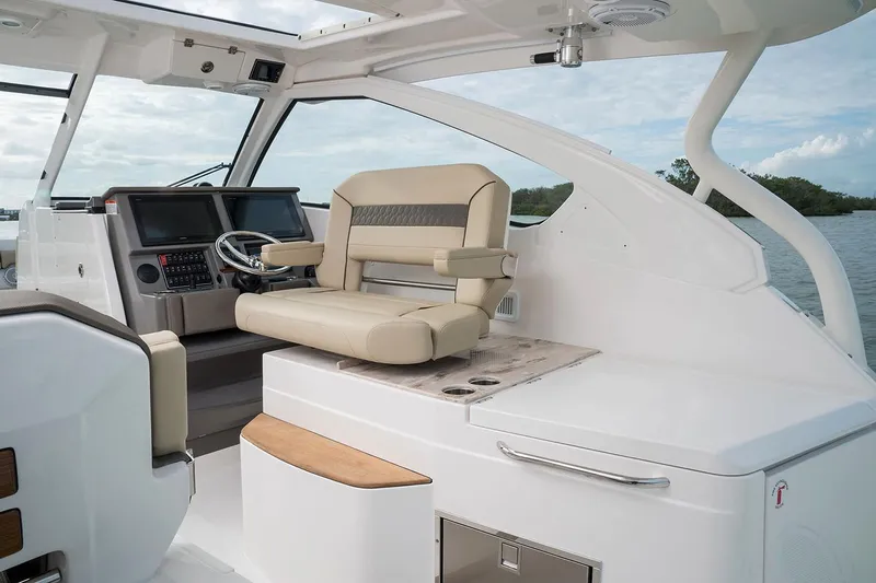  Yacht Photos Pics Manufacturer Provided Image: 2018 Pursuit DC 365 Dual Console boat interior with captain's chair and control panel.