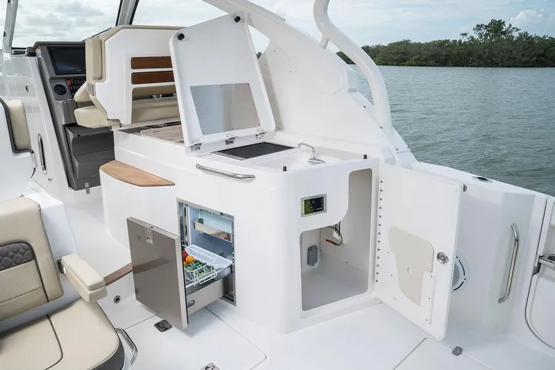  Yacht Photos Pics Manufacturer Provided Image: 2018 Pursuit DC 365 Dual Console boat interior with open storage compartments and mini fridge.