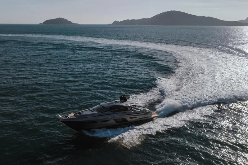 M/y "ghep" Yacht Photos Pics 2022 Pershing 7X yacht cruising on open sea with scenic island backdrop.