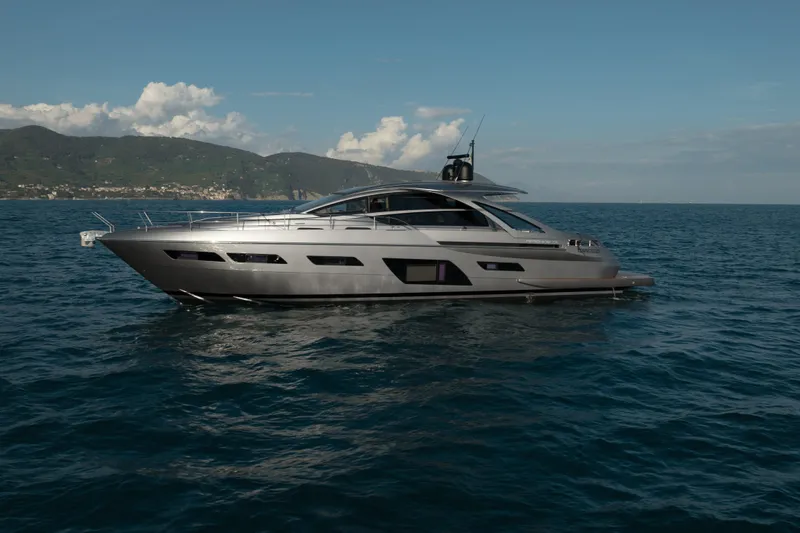 M/y "ghep" Yacht Photos Pics 2022 Pershing 7X yacht cruising on open sea with scenic mountain backdrop.