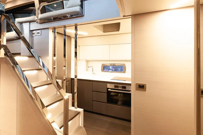 M/y "ghep" Yacht Photos Pics Luxurious interior of 2022 Pershing 7X yacht featuring modern kitchen and sleek staircase.