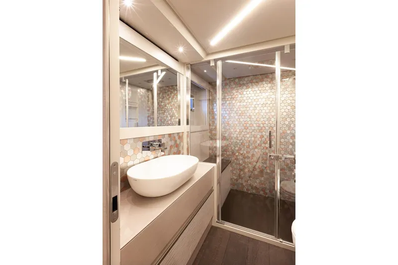 M/y "ghep" Yacht Photos Pics Luxurious bathroom in 2022 Pershing 7X yacht with modern fixtures and hexagonal tile design.