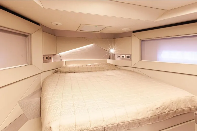 M/y "ghep" Yacht Photos Pics Luxurious bedroom interior of 2022 Pershing 7X yacht with modern design and ambient lighting.