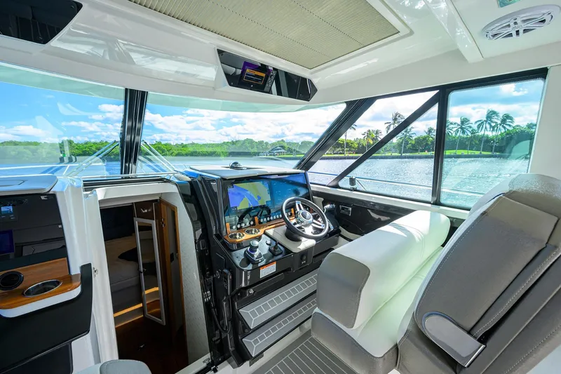 Let It Out Yacht Photos Pics Interior of 2022 Tiara Yachts 43 LE, featuring modern helm and scenic water view.