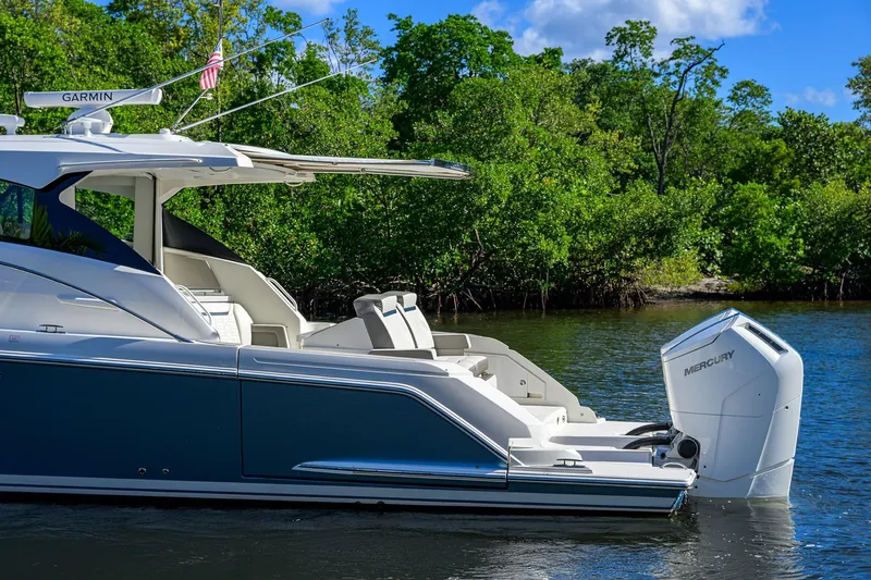 Let It Out Yacht Photos Pics 2022 Tiara Yachts 43 LE in water, featuring sleek design and Mercury outboard engine.