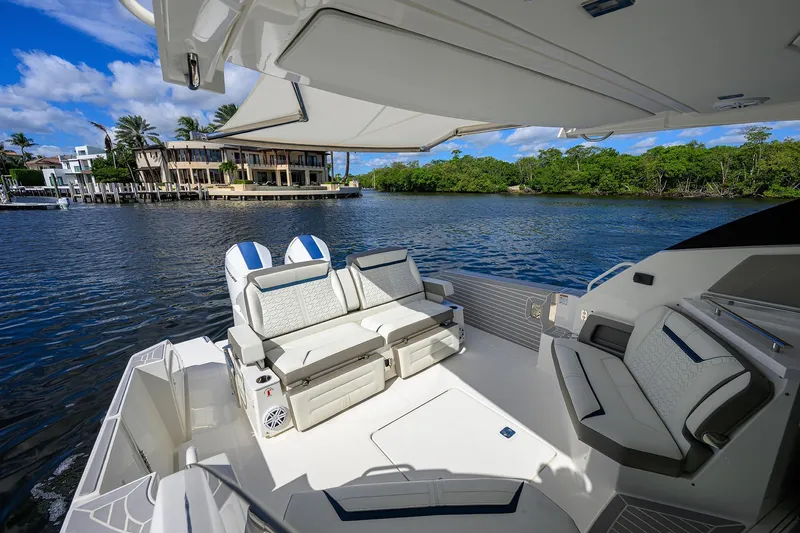 Let It Out Yacht Photos Pics Luxurious 2022 Tiara Yachts 43 LE interior with plush seating and scenic waterfront view.