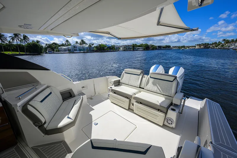 Let It Out Yacht Photos Pics Luxurious 2022 Tiara Yachts 43 LE with elegant seating, overlooking serene waterfront views.