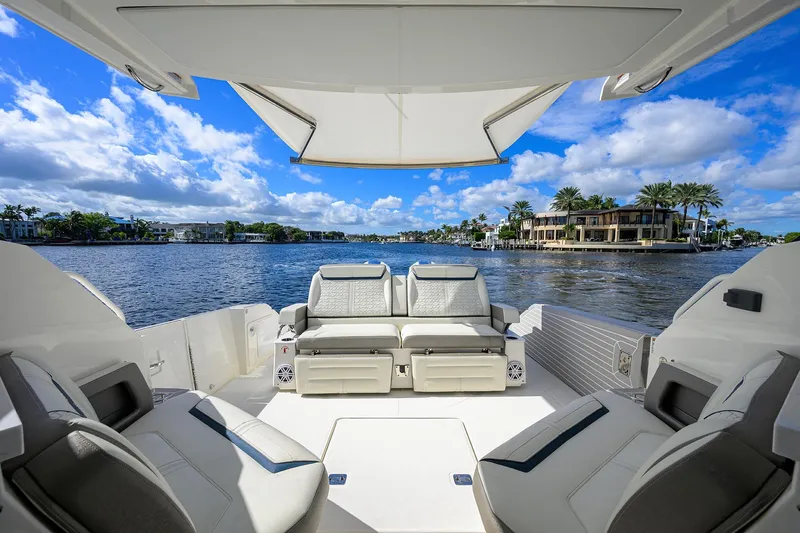 Let It Out Yacht Photos Pics 2022 Tiara Yachts 43 LE luxury yacht interior with waterfront view, featuring plush seating.