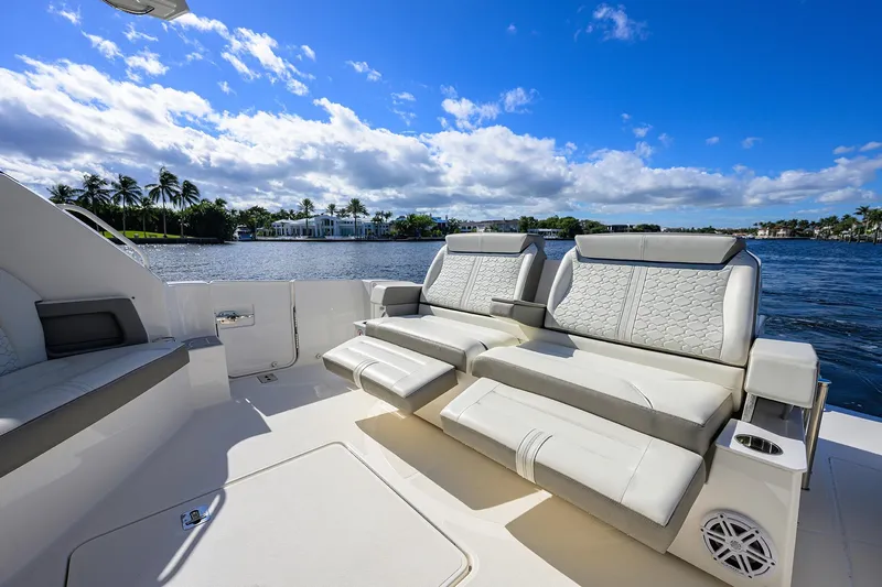 Let It Out Yacht Photos Pics Luxurious seating on 2022 Tiara Yachts 43 LE, overlooking serene waterfront and blue sky.