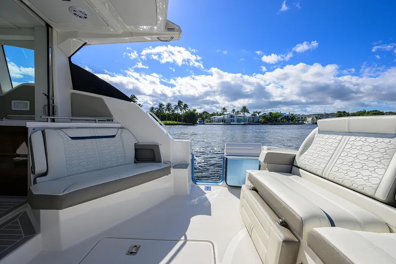 Let It Out Yacht Photos Pics 2022 Tiara Yachts 43 LE interior with luxurious seating, overlooking serene waterfront.