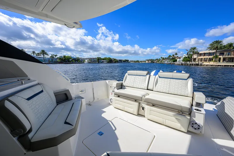 Let It Out Yacht Photos Pics Luxurious 2022 Tiara Yachts 43 LE interior with plush seating, overlooking serene waterfront views.