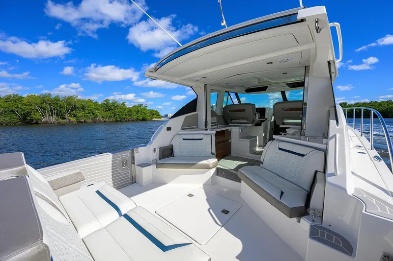 Let It Out Yacht Photos Pics 2022 Tiara Yachts 43 LE luxury yacht interior with seating, on a sunny day.