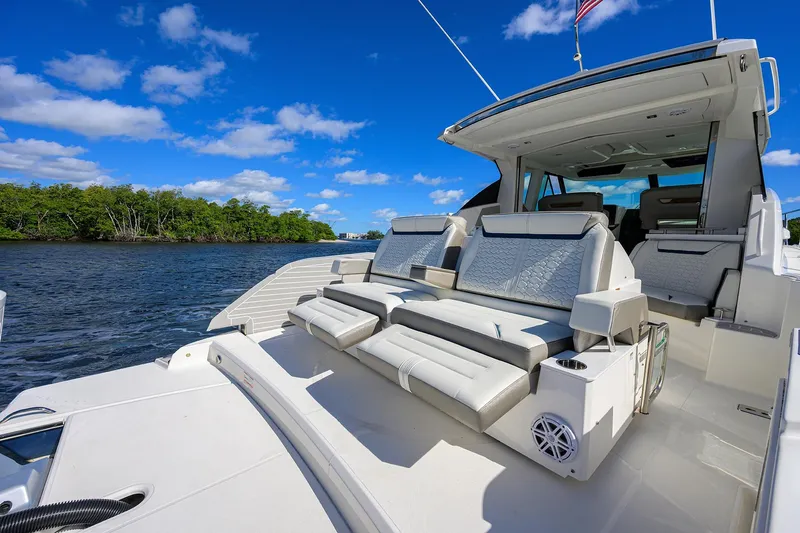 Let It Out Yacht Photos Pics 2022 Tiara Yachts 43 LE luxury yacht with spacious seating, cruising on a sunny day.