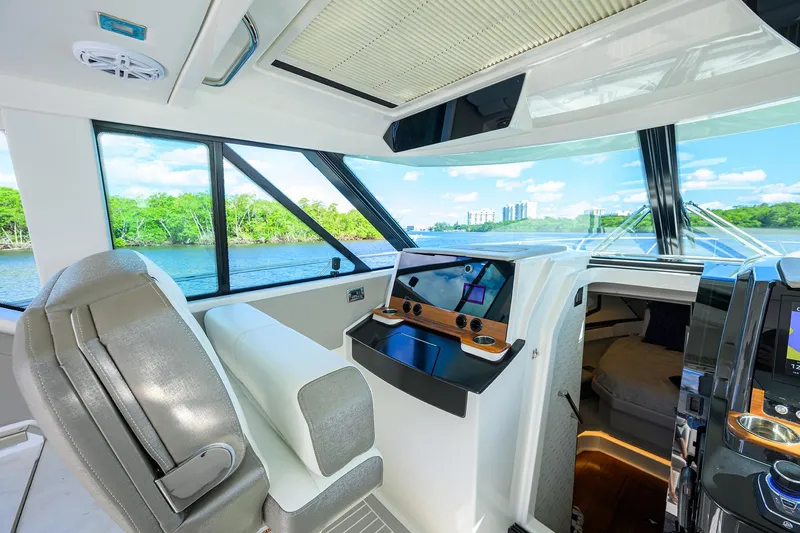 Let It Out Yacht Photos Pics 2022 Tiara Yachts 43 LE interior with modern helm and scenic water view.