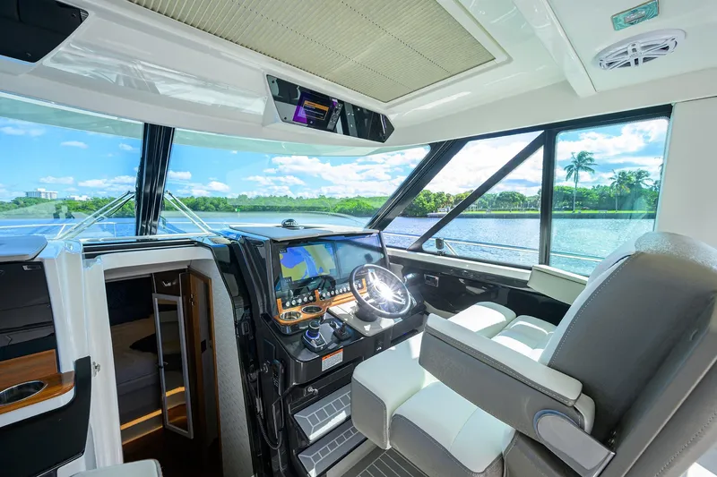 Let It Out Yacht Photos Pics 2022 Tiara Yachts 43 LE helm with modern navigation system and panoramic water views.