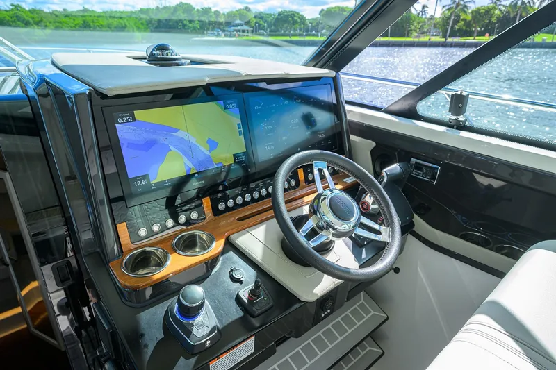 Let It Out Yacht Photos Pics 2022 Tiara Yachts 43 LE helm with advanced navigation displays and steering wheel.