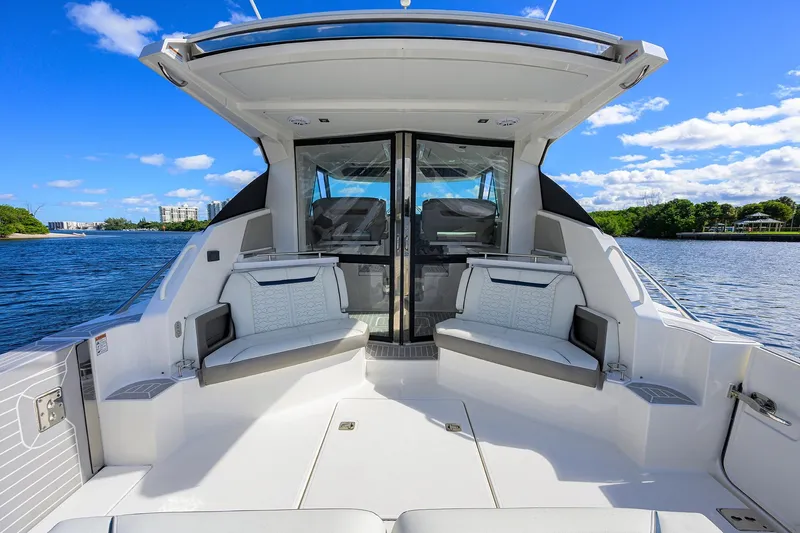 Let It Out Yacht Photos Pics 2022 Tiara Yachts 43 LE interior with seating, overlooking serene water and blue sky.