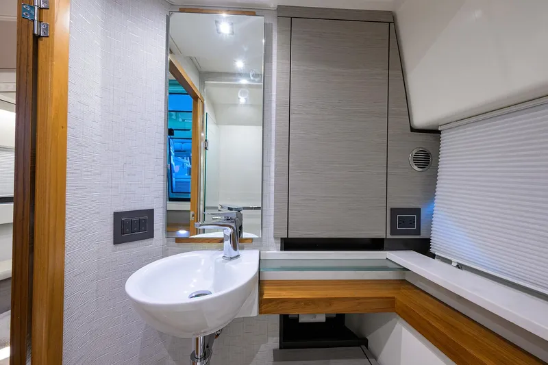 Let It Out Yacht Photos Pics 2022 Tiara Yachts 43 LE bathroom with modern sink and sleek cabinetry.