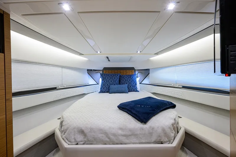 Let It Out Yacht Photos Pics Luxurious interior of 2022 Tiara Yachts 43 LE, featuring a cozy, well-lit bedroom.