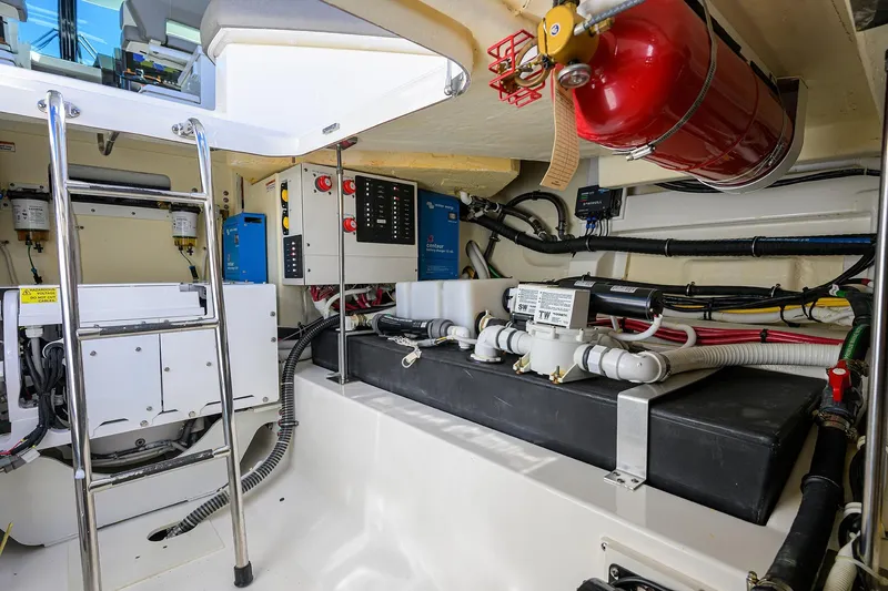 Let It Out Yacht Photos Pics Engine room of 2022 Tiara Yachts 43 LE with equipment and fire extinguisher.