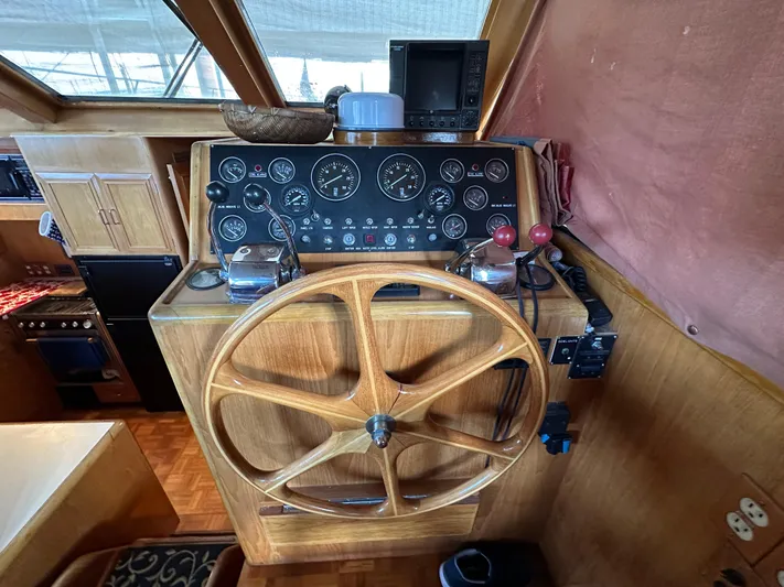  Yacht Photos Pics 1987 Ocean Alexander 46 Cockpit Motor Yacht helm with wooden wheel and control panel.