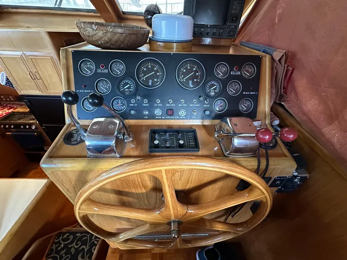  Yacht Photos Pics Control panel of a 1987 Ocean Alexander 46 Cockpit Motor Yacht with wooden steering wheel.