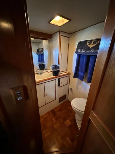  Yacht Photos Pics 1987 Ocean Alexander 46 Cockpit Motor Yacht bathroom with wood accents and nautical decor.