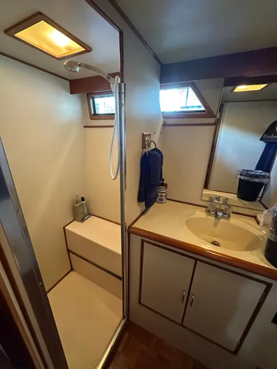  Yacht Photos Pics 1987 Ocean Alexander 46 Cockpit Motor Yacht bathroom with shower, sink, and storage cabinets.