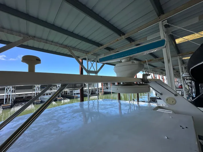 Yacht Photos Pics 1987 Ocean Alexander 46 Cockpit Motor Yacht under covered dock, showcasing radar equipment.