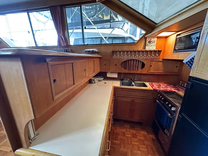  Yacht Photos Pics 1987 Ocean Alexander 46 Cockpit Motor Yacht kitchen with wood cabinetry and modern appliances.