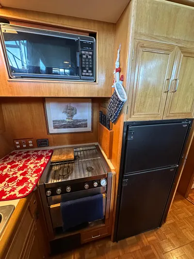  Yacht Photos Pics 1987 Ocean Alexander 46 Cockpit Motor Yacht kitchen with microwave, stove, and refrigerator.